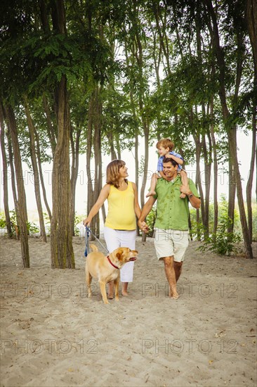 Family walking together on wooded beach