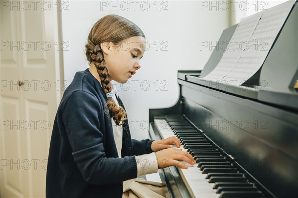 Mixed race girl playing piano