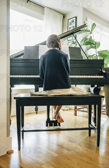 Mixed race girl playing piano