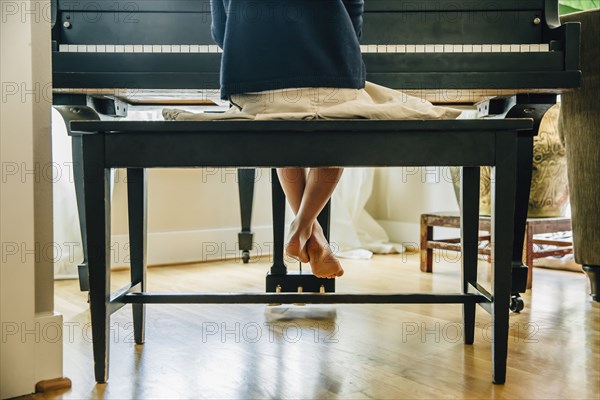 Mixed race girl playing piano