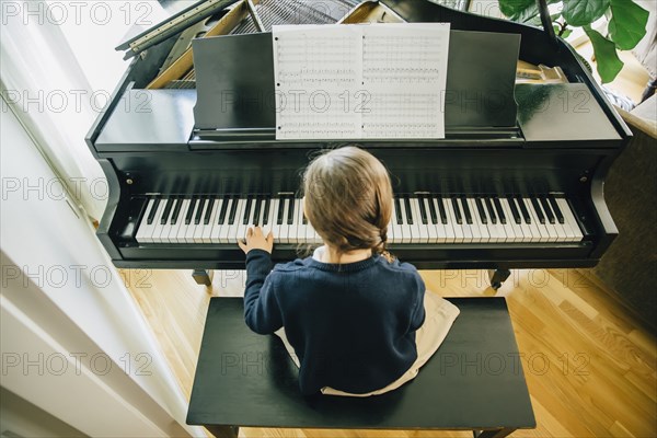 Mixed race girl playing piano