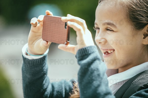 Mixed race girl using cell phone outdoors