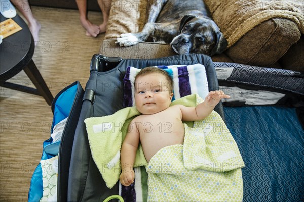 Caucasian baby boy laying on crib