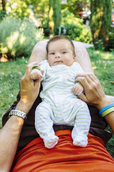 Caucasian father playing with baby boy in backyard