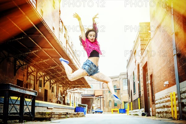 Caucasian woman dancing in street