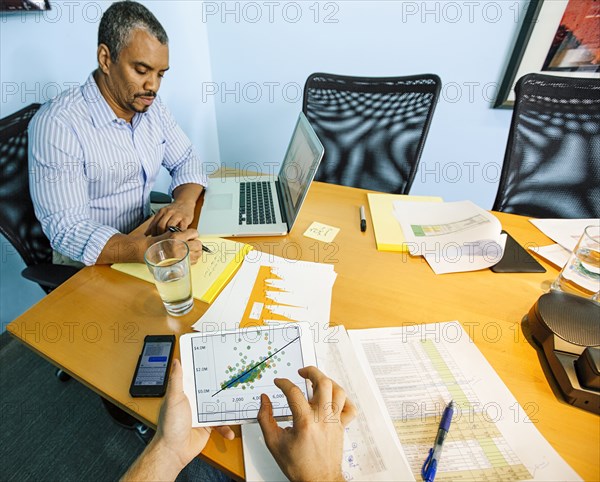 Businessmen working at conference table in office
