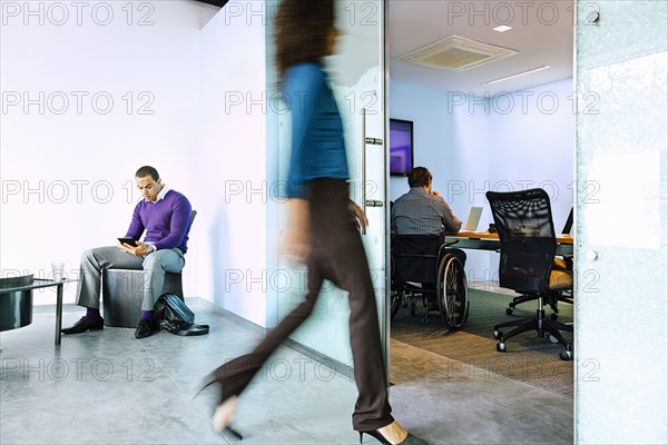 Blurred view of businesswoman walking in office