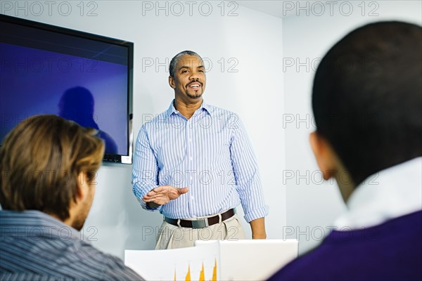 Businessman giving presentation in office meeting