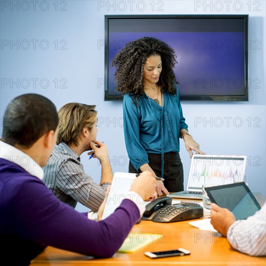 Businesswoman giving presentation in office meeting