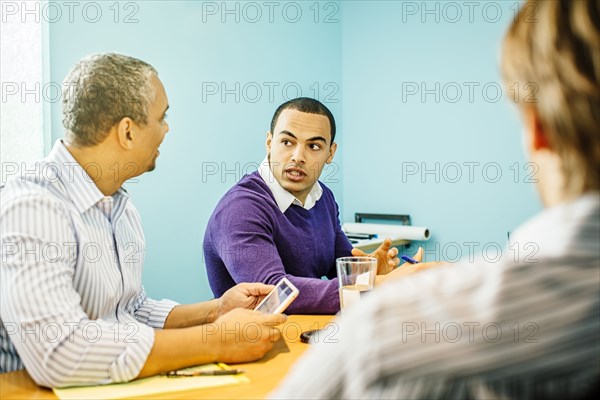 Businessmen talking in office meeting