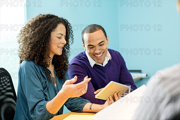 Business people using digital tablet in office meeting