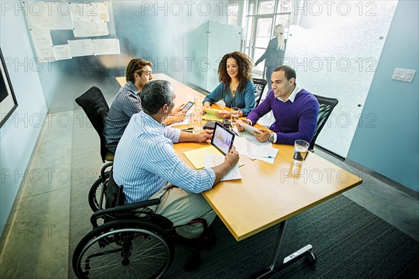 Business people using digital tablets in office meeting