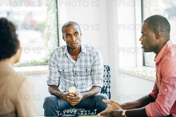 Business people talking in office lobby