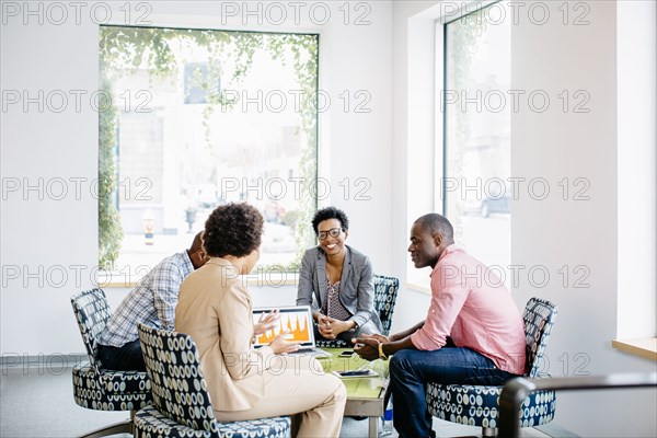 Business people talking in office lobby