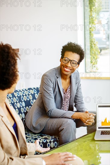 Businesswomen talking in office lobby