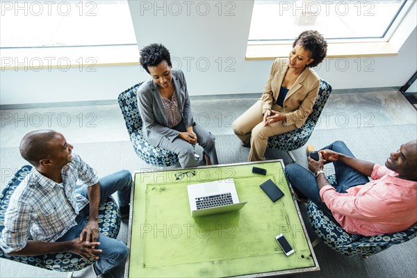 High angle view of business people talking in office lobby