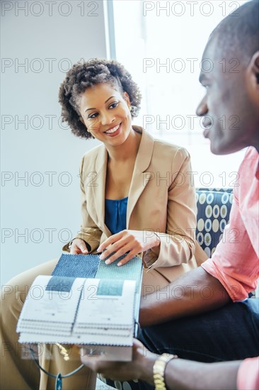 Business people examining swatches in office lobby