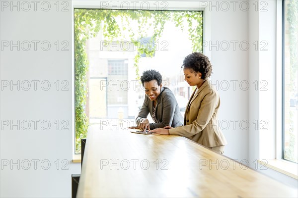 Businesswomen using digital tablet in office