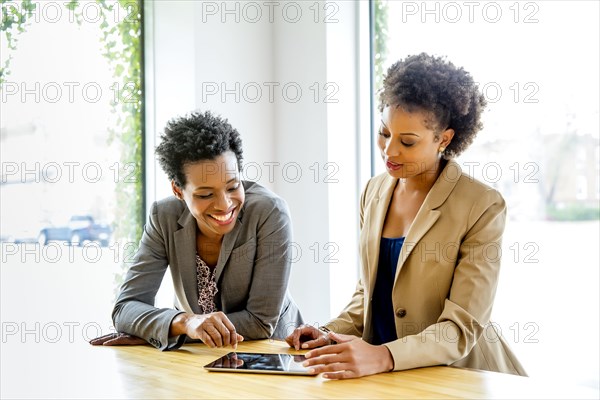 Businesswomen using digital tablet in office