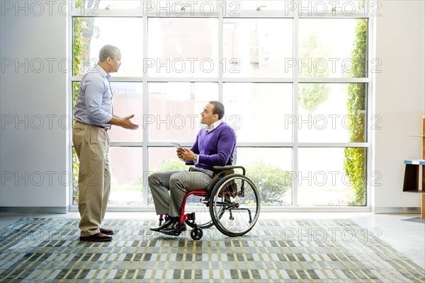 Businessmen talking in office