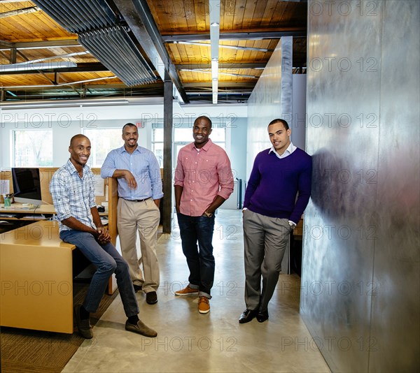 Businessmen smiling in office