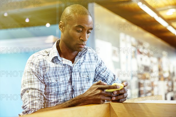 Businessman using cell phone in office