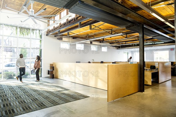 Business people talking in office lobby