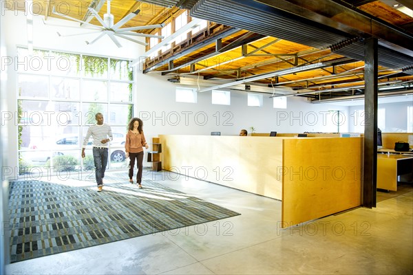 Business people walking in office lobby