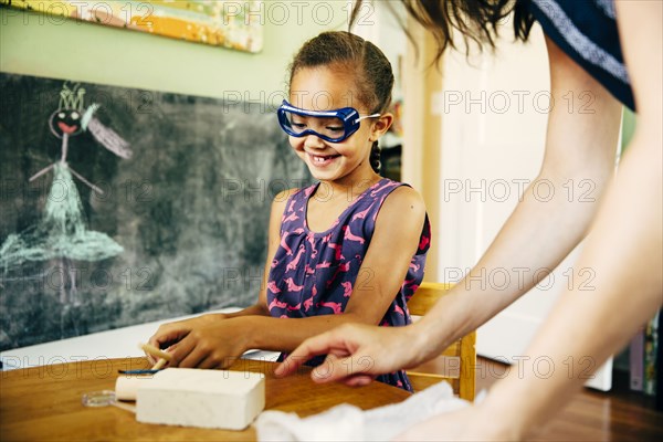 Mother and daughter doing science experiment at home