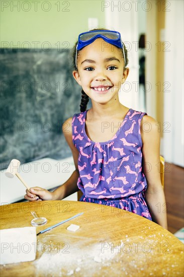 Mixed race girl doing science experiment at home