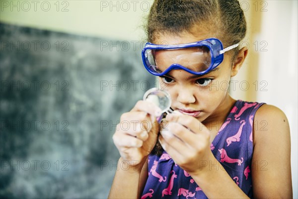 Mixed race girl doing science experiment at home