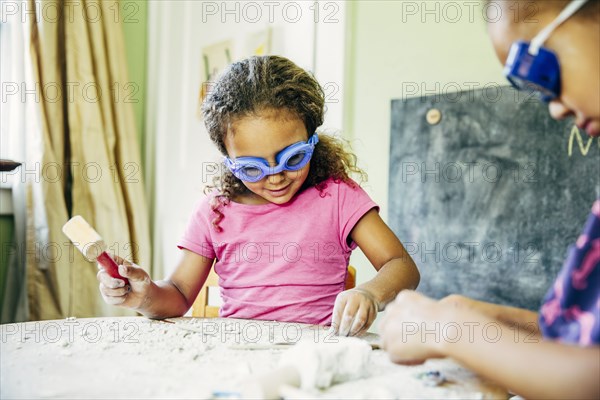 Mixed race sisters doing science experiment at home