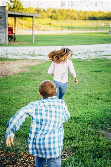 Caucasian children playing on farm