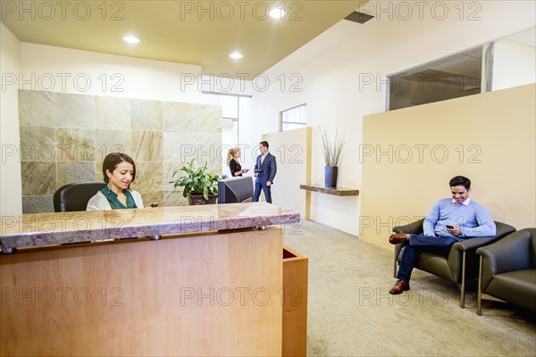 Business people working in office lobby