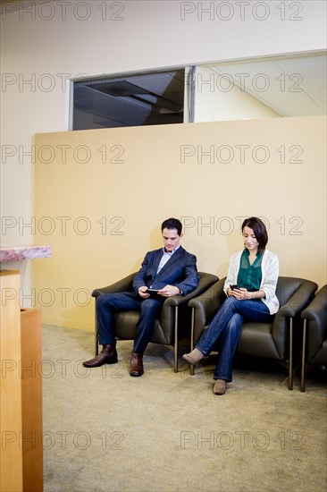Business people waiting in office lobby