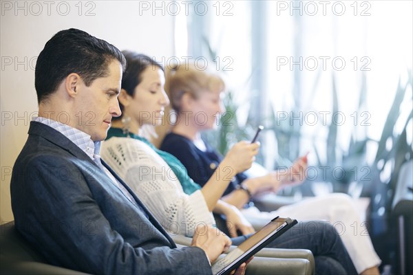 Business people waiting in office lobby