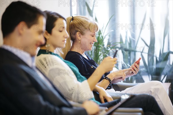 Business people waiting in office lobby