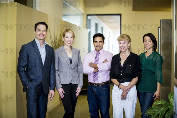 Business people smiling in office lobby