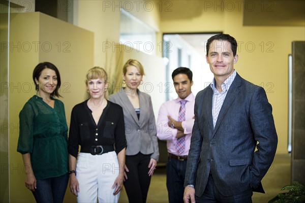 Business people smiling in office lobby