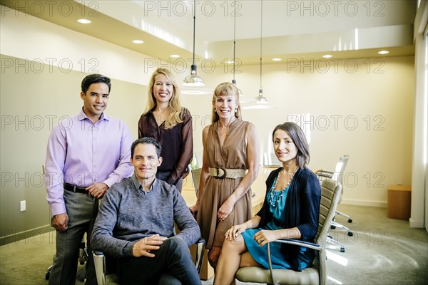 Business people smiling in office meeting