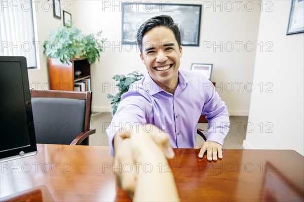 Business people shaking hands in office