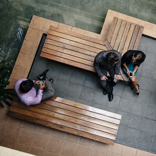 Overhead view of business people sitting in office courtyard