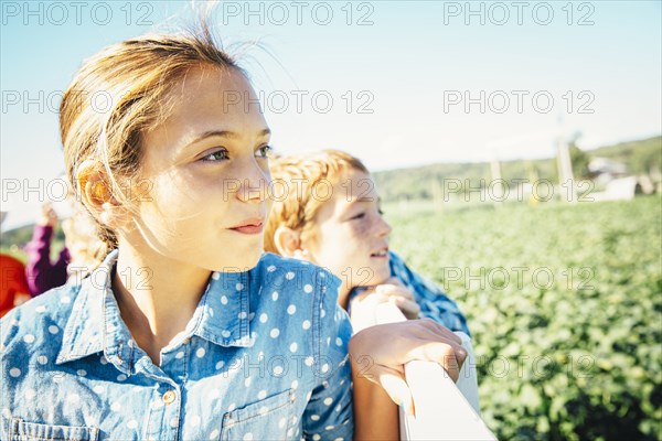 Close up of Caucasian brother and sister admiring farm