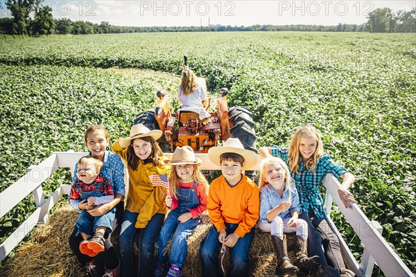 Caucasian family smiling on hay ride