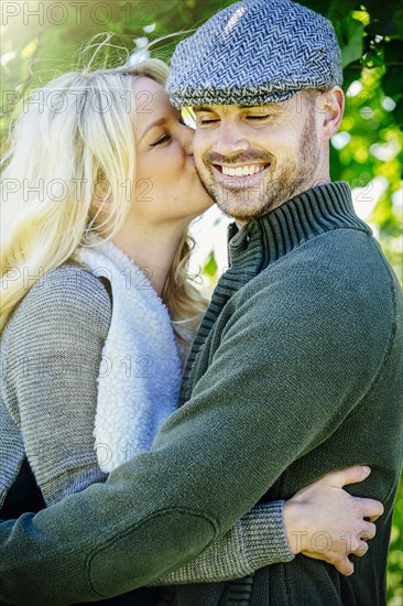 Caucasian couple kissing outdoors