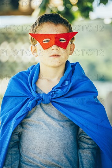 Caucasian boy wearing superhero costume