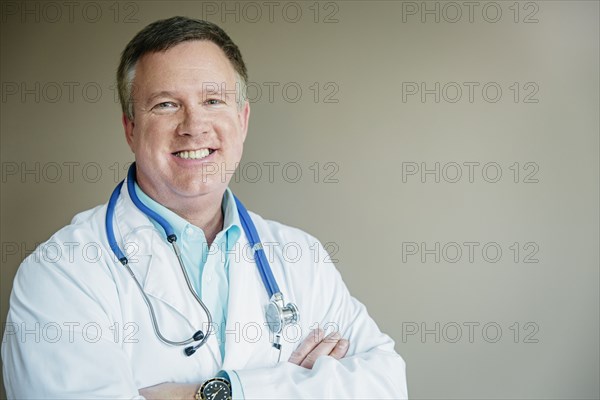 Caucasian doctor standing with arms crossed