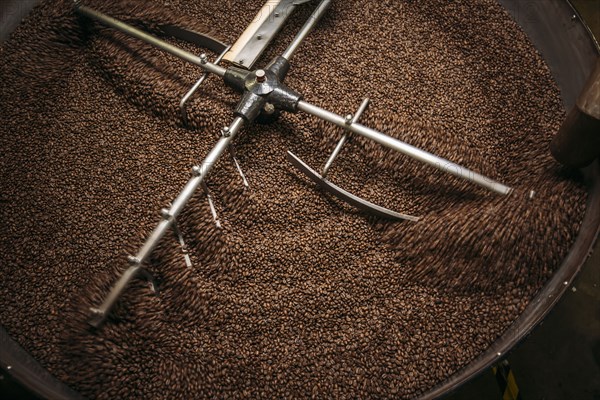 High angle view of equipment and beans in coffee roaster