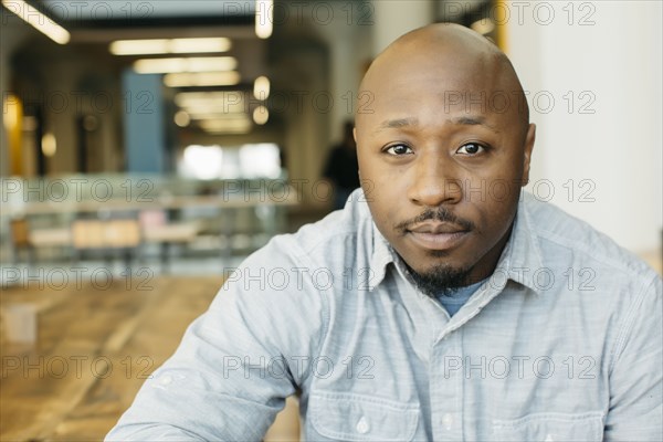 Black man sitting in cafe