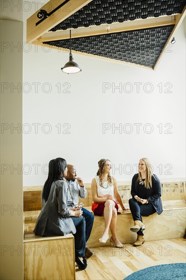 Business people talking in office lobby